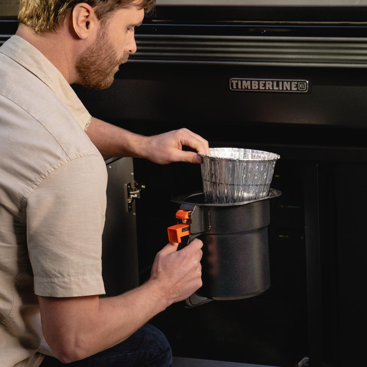 Traeger BAC608 Grease & Ash Keg Liner 5 Pack - Placing Liner in Timberline Grease & Ash Keg